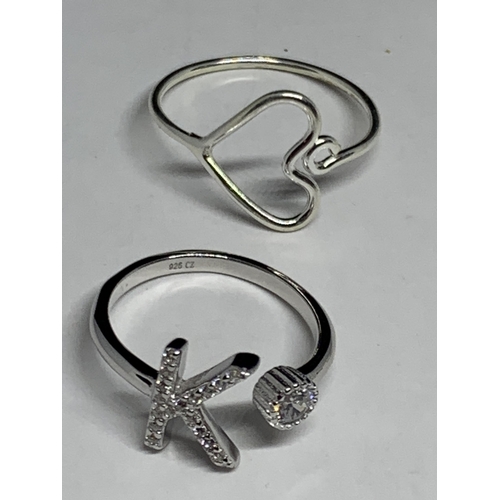 676 - FOUR MARKED SILVER RINGS TO INCLUDE A K INITIAL AND A GOLD PLATED WISHBONE