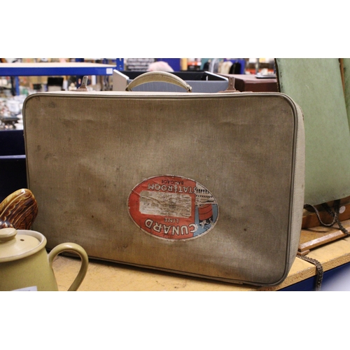 944 - A VINTAGE SUITCASE BEARING A 'CUNARD LINE STATEROOM BAGGAGE' STICKER