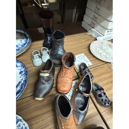 1169 - A LARGE COLLECTION OF POTTERY BOOTS AND CLOGS