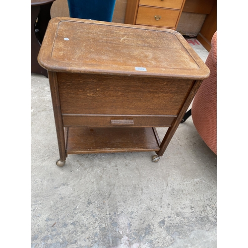 3069 - A MID 20TH CENTURY OAK SEWING BOX/TABLE ON CASTERS