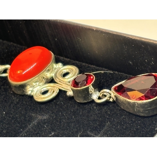 624 - A PAIR OF MARKED SILVER CORAL AND GARNET EARRINGS IN A PRESENTATION BOX