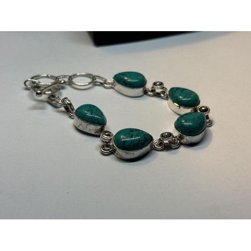 626 - A MARKED SILVER BRACELET WITH NAVAJO TURQUOISE STONES IN A PRESENTATION BOX