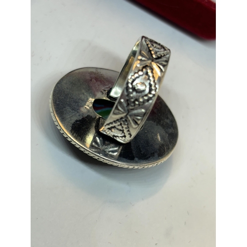 630 - A MARKED SILVER RING WITH A LARGE RAINBOW CALISICA STONE SIZE O IN A PRESENTATION BOX