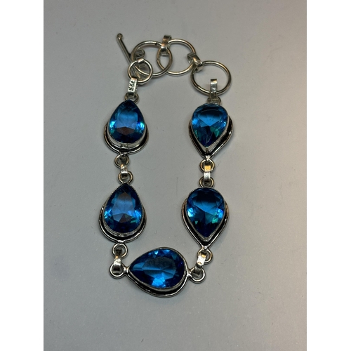 632 - A MARKED SILVER BRACELET WITH FIVE TEARDROP BLUE TOPAZ STONES IN A PRESENTATION BOX