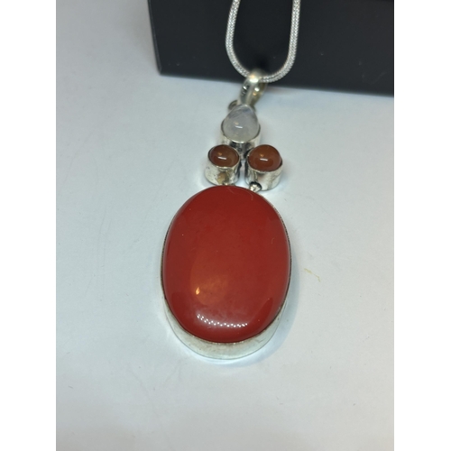 633 - A MARKED SILVER NECKLACE WITH RED CORAL PENDANT IN A PRESENTATION BOX