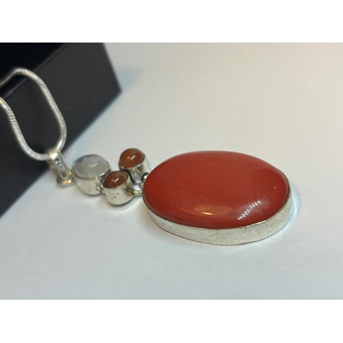 633 - A MARKED SILVER NECKLACE WITH RED CORAL PENDANT IN A PRESENTATION BOX