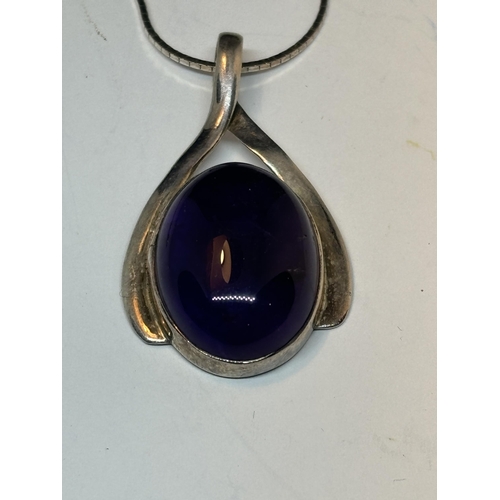 641 - A MARKED SILVER NECKLACE AND PENDANT WITH A LARGE PURPLE STONE