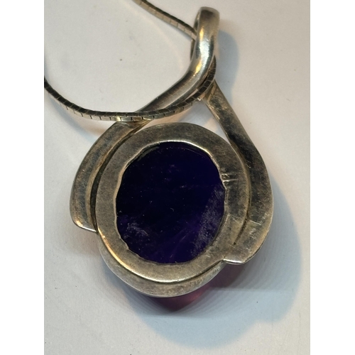 641 - A MARKED SILVER NECKLACE AND PENDANT WITH A LARGE PURPLE STONE