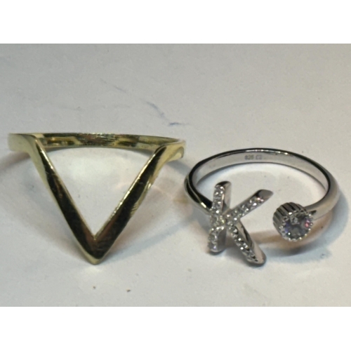 643 - FOUR MARKED SILVER RINGS TO INCLUDE A K INITIAL AND A GOLD PLATED WISHBONE