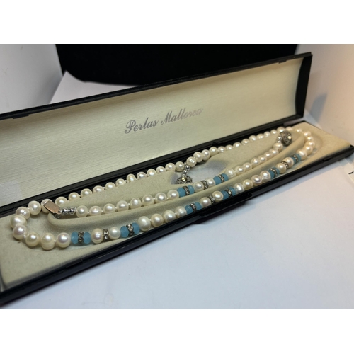 649 - A BOXED FRESHWATER PEARL SET TO INCLUDE A NECKLACE AND BRACELET