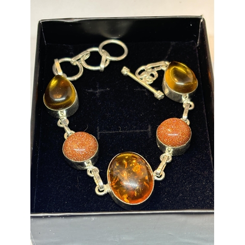 657 - A MARKED SILVER BRACELET WITH AMBER AND GOLDSTONE IN A PRESENTATION BOX