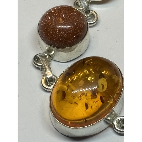 657 - A MARKED SILVER BRACELET WITH AMBER AND GOLDSTONE IN A PRESENTATION BOX