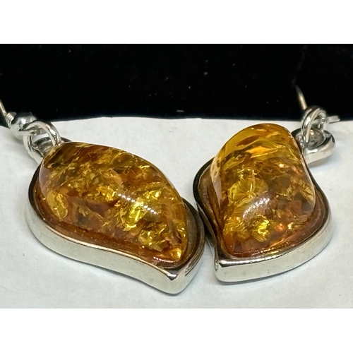 659 - A PAIR OF MARKED SILVER AND PRESSED AMBER DROP EARRINGS IN A PRESENTATION BOX