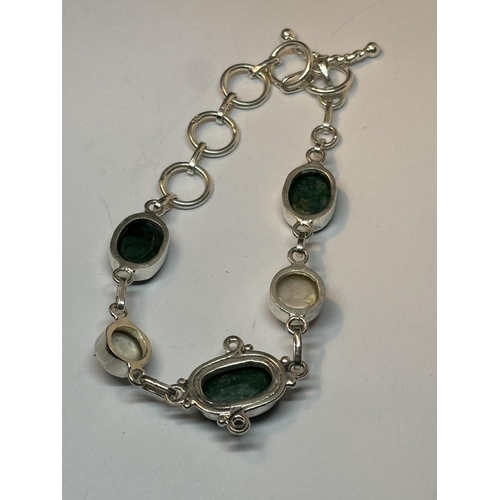 661 - A MARKED SILVER EMERALD AND PEARL BRACELET IN A PRESENTATION BOX