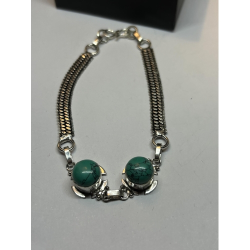 663 - A MARKED SILVER BRACELET WITH TURQUOISE NAVAJO STONES IN A PRESENTATION BOX