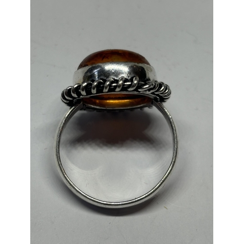 665 - A MARKED SILVER RING WITH CIRCULAR AMBER STONE SIZE N IN A PRESENTATION BOX