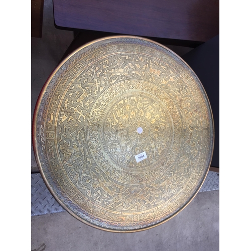 2604 - AN ANGLO INDIAN TABLE WITH EMBOSSED BRASS TOP, 23.5