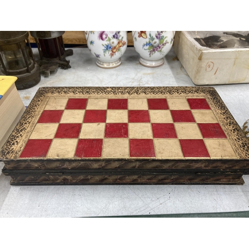 15 - A VINTAGE CHESS, DRAUGHTS, BACKGAMMON BOX BOARD WITH A QUANTITY OF VARIOUS COUNTERS, SHAKERS, DICE E... 