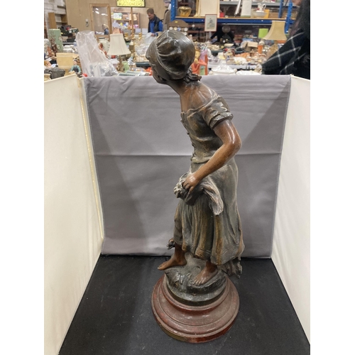 24 - A BRONZE EFFECT SCULPTURE OF A LADY WITH GEESE ON A WOODEN BASE