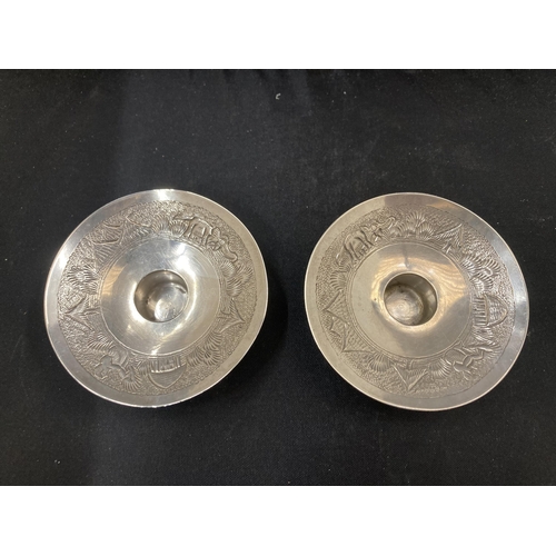 31 - A PAIR OF MARKED STERLING SILVER DECORATIVE ORIENTAL DESIGN CANDLE HOLDERS GROSS WEIGHT 110.5 GRAMS