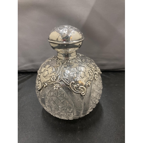 6 - A CUT GLASS PERFUME BOTTLE WITH A DECORATIVE  HALLMARKED BIRMINGHAM SILVER SHOULDERS AND TOP COMPLET... 