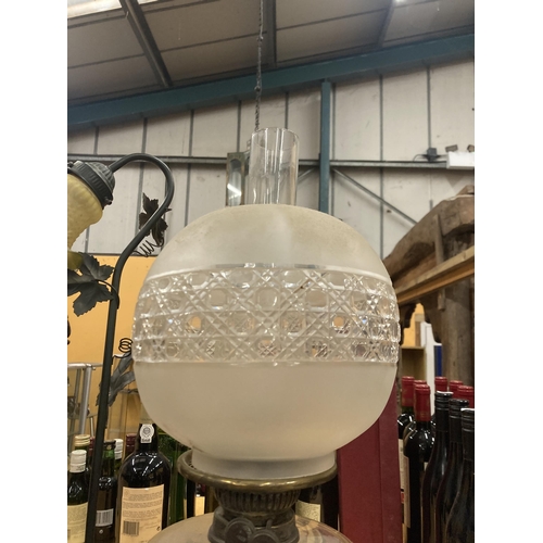 61 - A VICTORIAN OIL LAMP WITH MILKY GLASS SHADE AND GLASS RESERVOIR ON A BRASS COLUMN AND BLACK PLINTH