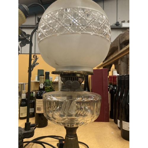 61 - A VICTORIAN OIL LAMP WITH MILKY GLASS SHADE AND GLASS RESERVOIR ON A BRASS COLUMN AND BLACK PLINTH