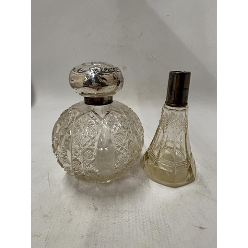 70 - TWO CUT GLASS PERFUME BOTTLES ONE WITH STOPPER AND LID INDISTINCT HALLMARK AND ONE WITH A HALLMARKED... 