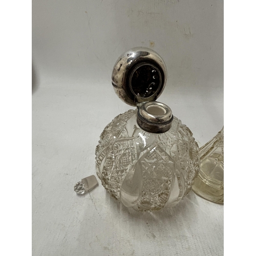 70 - TWO CUT GLASS PERFUME BOTTLES ONE WITH STOPPER AND LID INDISTINCT HALLMARK AND ONE WITH A HALLMARKED... 