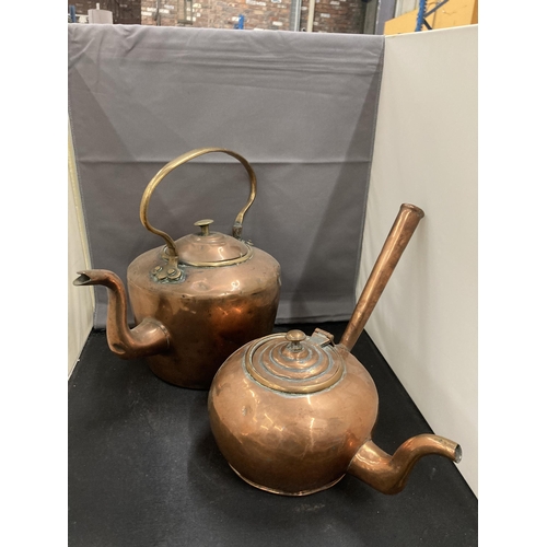 77 - TWO COPPER KETTLES TO INCLUDE AN UNUSUAL ROUND TAPERING DESIGN WITH A HANDLE ATTACHED TO THE MAIN BO... 