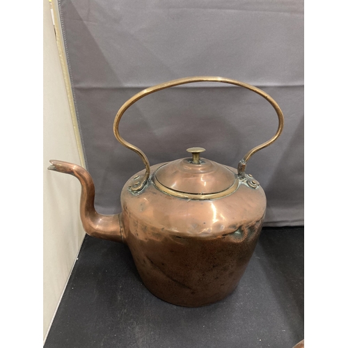 77 - TWO COPPER KETTLES TO INCLUDE AN UNUSUAL ROUND TAPERING DESIGN WITH A HANDLE ATTACHED TO THE MAIN BO... 