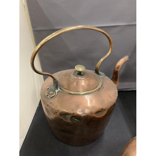 77 - TWO COPPER KETTLES TO INCLUDE AN UNUSUAL ROUND TAPERING DESIGN WITH A HANDLE ATTACHED TO THE MAIN BO... 