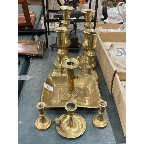 92 - EIGHT CIRCA 18TH CENTURY BRASS CANDLESTICKS TO INCLUDE THREE PAIRS AND TWO CHAMBER STICKS