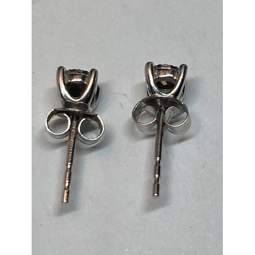 606 - A PAIR OF WHITE GOLD DIAMOND SOLITAIRE EARRINGS IN A PRESENTATION BOX