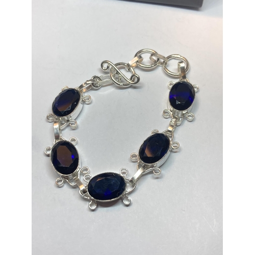 688 - A MARKED SILVER BRACELET WITH BLUE STONES IN A PRESENTATION BOX