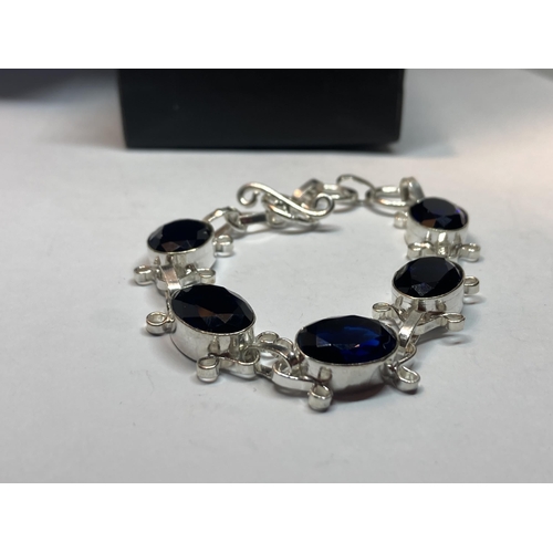 688 - A MARKED SILVER BRACELET WITH BLUE STONES IN A PRESENTATION BOX