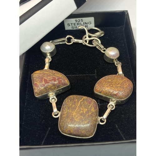 690 - A MARKED SILVER BRACELET WITH PEARLISED AND NATURAL STONES IN A PRESENTATION BOX