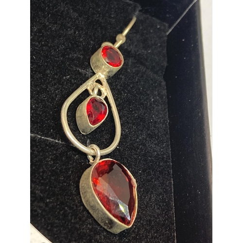 701 - A PAIR OF MARKED SILVER EARRINGS WITH GARNETS IN A PRESENTATION BOX