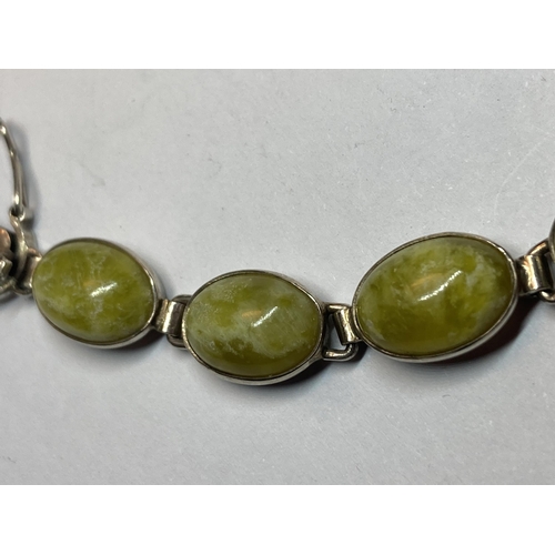 715 - A MARKED SILVER BRACELET WITH GREEN SEMI PRECIOUS STONES