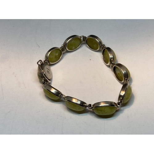 715 - A MARKED SILVER BRACELET WITH GREEN SEMI PRECIOUS STONES