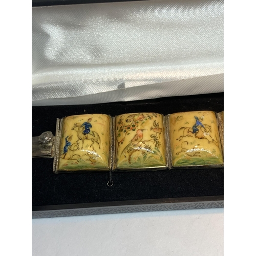 727 - A PAINTED PANEL STORY BRACELET IN A PRESENTATION BOX