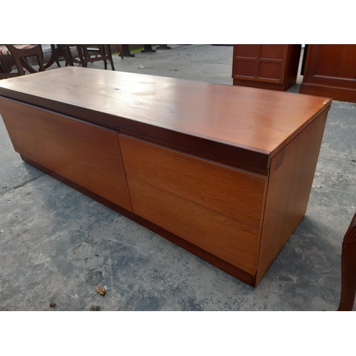 2886B - A RETRO TEAK LOW UNIT ENCLOSING TWO DRAWERS AND PULL DOWN FLAP, 60