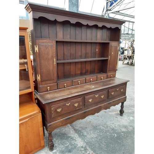 2889 - A GEORGIAN OAK DRESSER WITH THREE DRAWERS TO BASE AND PLATE RACK ENCLOSING TWO CUPBOARDS WITH H BRAS... 