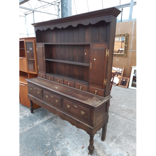 2889 - A GEORGIAN OAK DRESSER WITH THREE DRAWERS TO BASE AND PLATE RACK ENCLOSING TWO CUPBOARDS WITH H BRAS... 