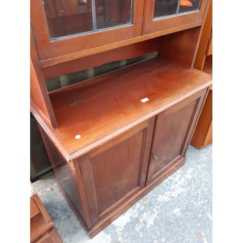 2891 - A VICTORIAN MAHOGANY TWO DOOR GLAZED AND LEADED CABINET WITH CUPBOARDS TO BASE, 40