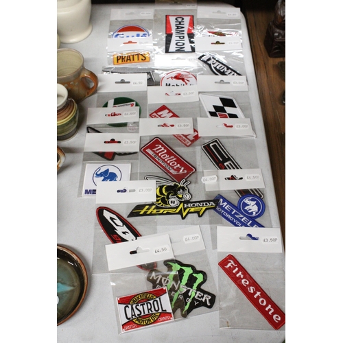 1159 - TWENTY MOTOR CYCLE THEMED SEW ON BADGES TO INCLUDE TRIUMPH, HONDA, GULF, ETC - ALL NEW IN PACKAGING