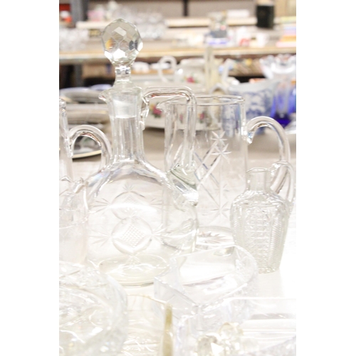 1164 - A QUANTITY OF GLASSWARE TO INCLUDE WATER JUGS, A DECANTER, VASES, ETC