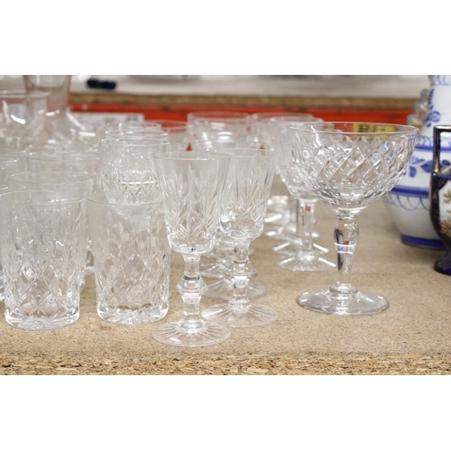 1199 - A QUANTITY OF DRINKING GLASSES TO INCLUDE A GLASS CARAFE