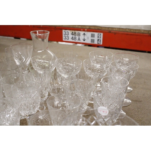 1199 - A QUANTITY OF DRINKING GLASSES TO INCLUDE A GLASS CARAFE