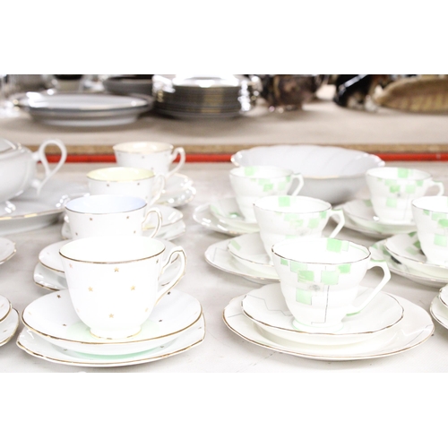 1287 - AN ASSORTMENT OR CERAMICS TO INCLUDE TEA CUPS AND SAUCERS, A SUGAR AND CREAMER, A LARGE BOWL ETC